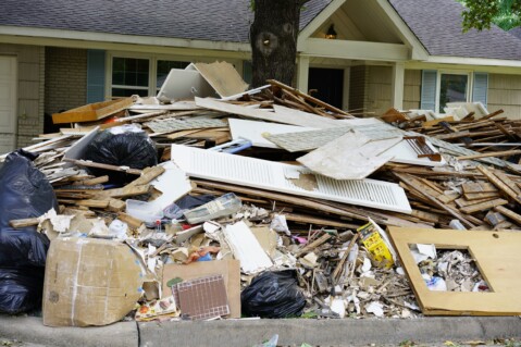Debris in front of a house after hurricane harvey