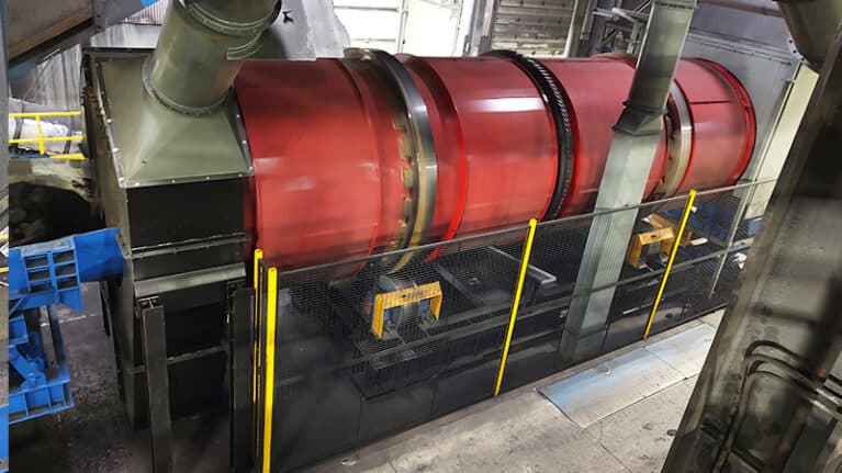 A photo of a red GK Rotary Foundry Drum on-site