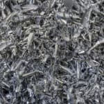Close-up scene of aluminum materials scrap from turning process. The pile of lathe chips.