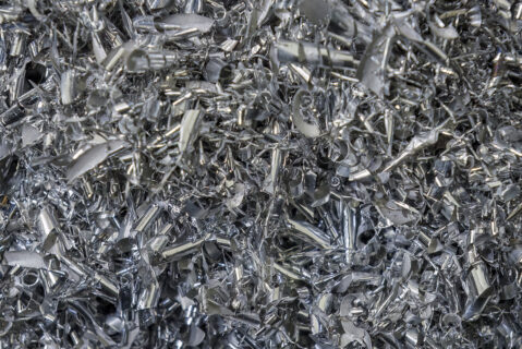 Close-up scene of aluminum materials scrap from turning process. The pile of lathe chips.