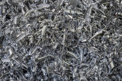 Close-up scene of aluminum materials scrap from turning process. The pile of lathe chips.