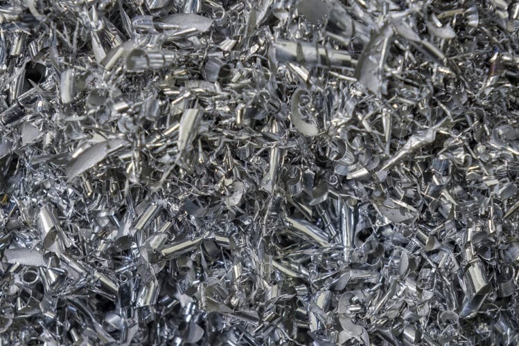 Close-up scene of aluminum materials scrap from turning process. The pile of lathe chips.