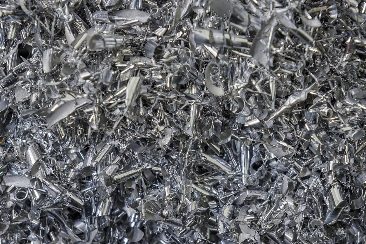 Close-up scene of aluminum materials scrap from turning process. The pile of lathe chips.